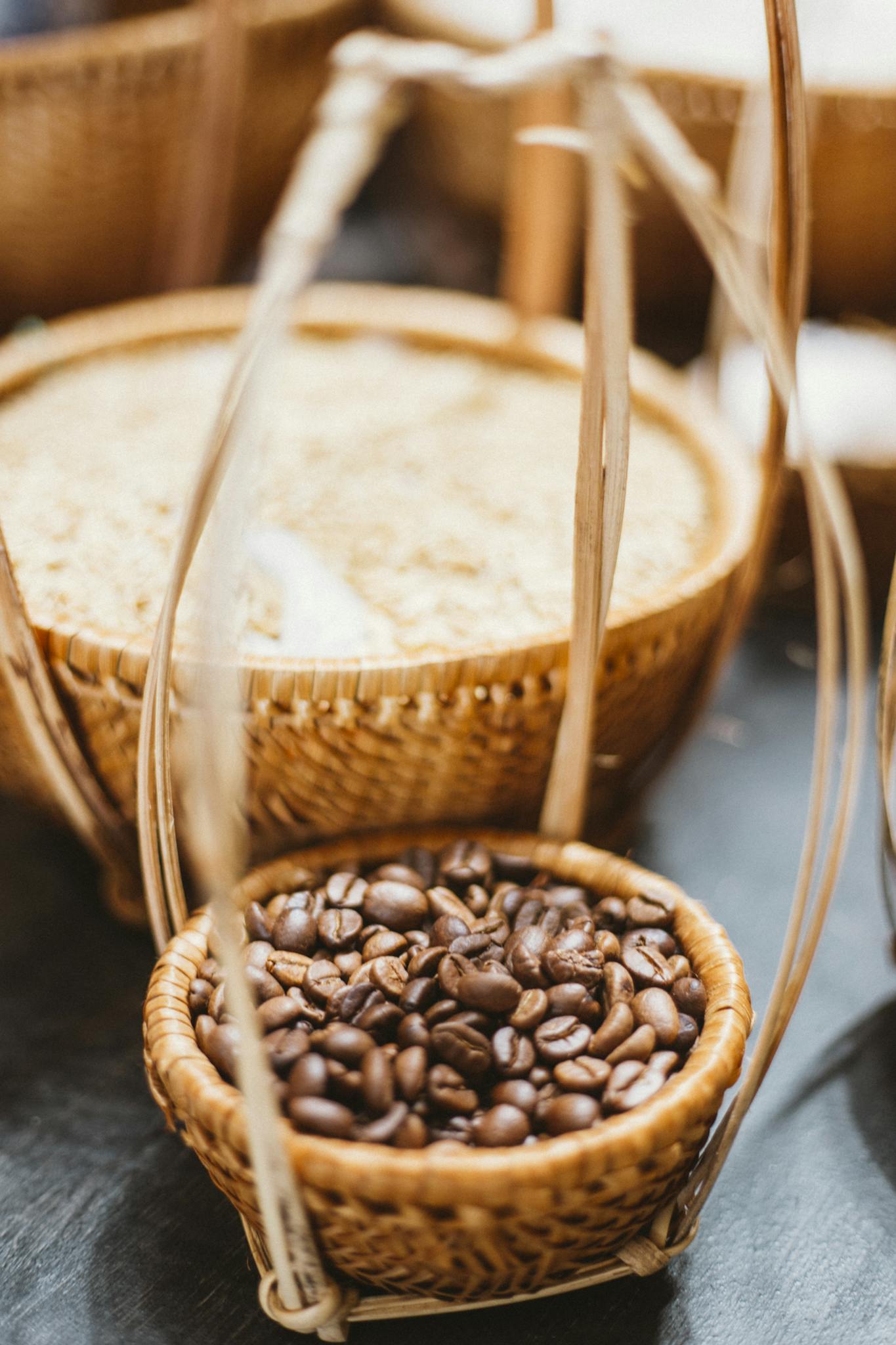 A wicker basket filled with roasted coffee beans on display, highlighting their rich texture.